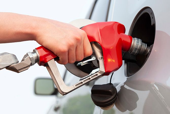 Fueling Our Success - closeup of a hand filling up a gas tank