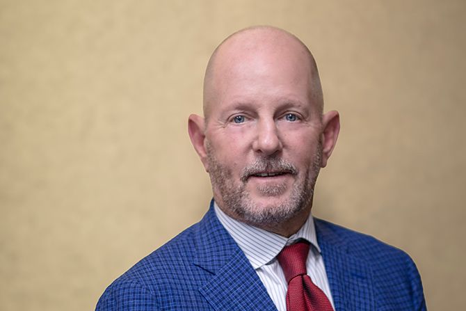 Rob King - man in blue suit and red tie