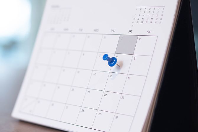 Calendar with a pin marking a date