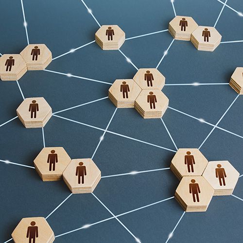 2026 NCADA Partners; Wooden hexagons with human icons are connected by white lines on a blue background, symbolizing a network or social connection concept.